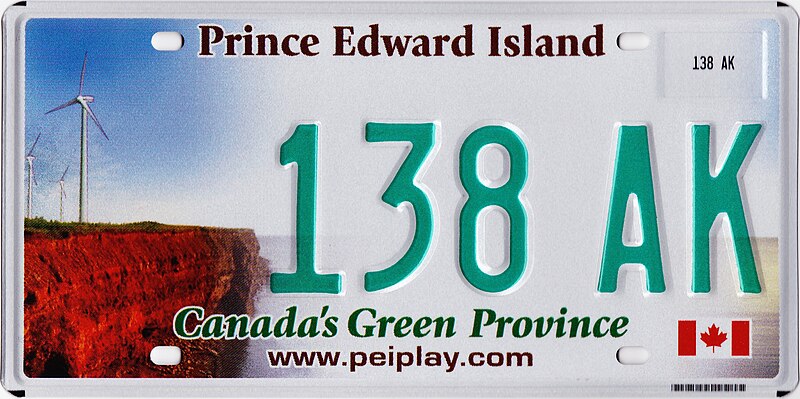 White license plate with photo of wind turbines on a red-soil cliff and the text Prince Edward Island at the top, and stylized text Canada's Green Provice www.peiplay.com at the bottom.