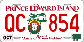 White license plate with red stylized text reading PRINCE EDWARD ISLAND along the top, a plate number of QC 854, an illustration of Anne of Green Gables and Green Gables House and the phrase 'Home of Anne of Green Gables' at the bottom.