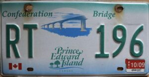 White license plate with green gradient at the top and blue gradient at the bottom and the text Confederation Bridge at the top, and stylized text Prince Edward Island at the bottom. In the middle is a stylized illustration of the Confederation Bridge.