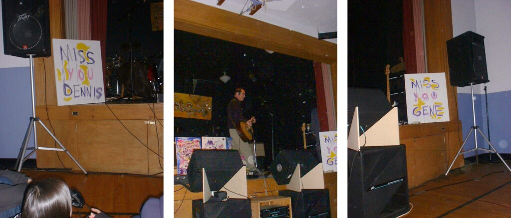 Three photos in a row. The first is a stage with speaker and a painting reading MISS YOU DENNIS. The second is Mike Knott performing on the same stage with acoustic guitar. The third is the other side of the stage with another similar painting reading MISS YOU GENE.